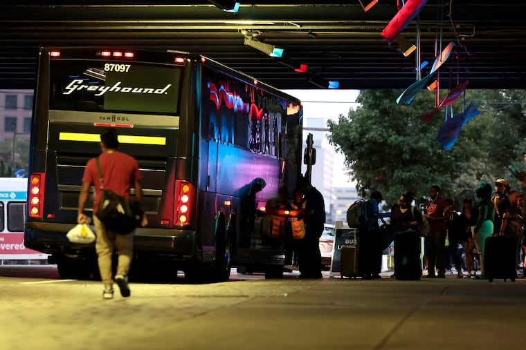 Travelers wait to board a Greyhound bus under the 95 overpass on Spring Garden Street, near North Second Street, in Philadelphia on Friday evening, August 2, 2024.