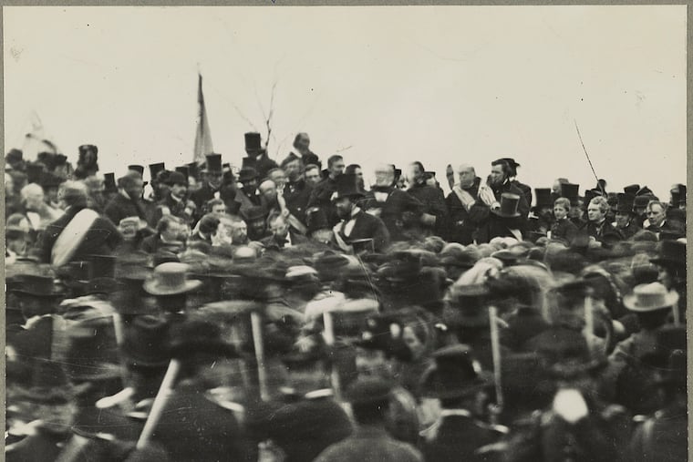 A reprint of a small detail of a photo showing the crowd gathered for the dedication of the Soldiers' National Cemetery in Gettysburg, Pa., where President Abraham Lincoln gave his now famous speech, the Gettysburg Address. Lincoln is visible facing the crowd, not wearing a hat, about an inch below the third flag from the left. Josephine Cobb first found Lincoln's face while working with a glass plate negative at the National Archives in 1952.