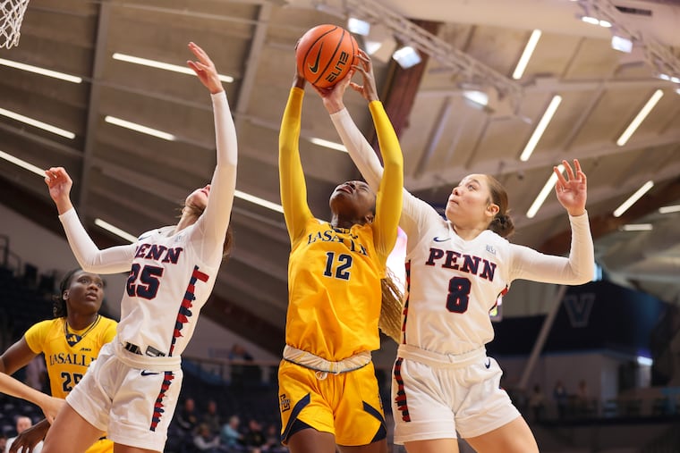 Penn’s Katie Collins (left), La Salle’s Ayisse Magassa (center), and Penn’s Sarah Miller battle for a rebound in the first quarter. Miller scored a game-high 21 points.