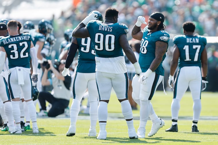 Eagles defensive lineman Jordan Davis (center) has played a big part in the Eagles' defense as a run-stopper.
