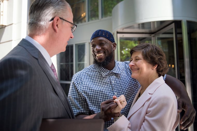 Shaurn Thomas embraces his attorneys with the Pennsylvania Innocence Project after he was released from custody in 2017.