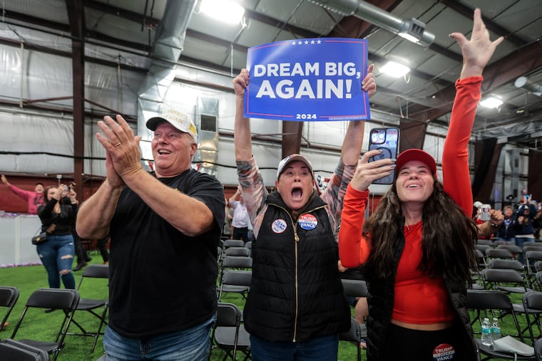 (From left) Larry Silcox, Bertha Rosenberg, and Chessy Engro celebrate Donald Trump clinching Pennsylvania in the presidential race at a watch party in Newtown Wednesday morning.