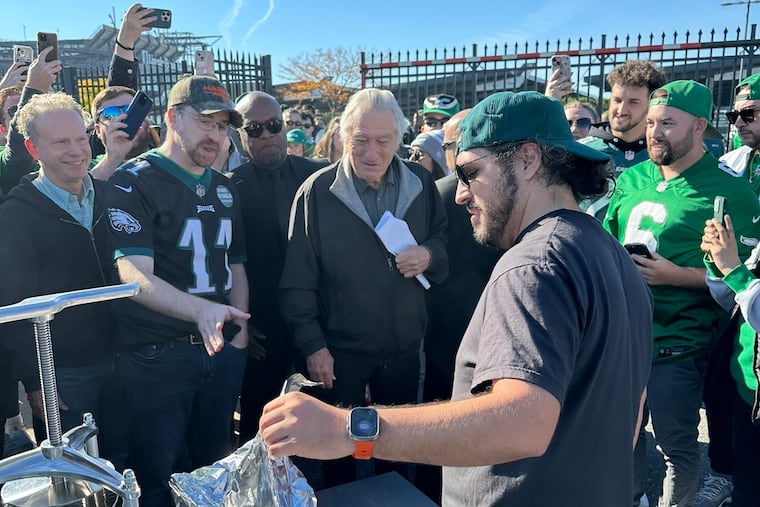Actor Robert De Niro (center) stops by Dylan Marck's (foreground) Eagles tailgate before the team's game against the Jacksonville Jaguars.