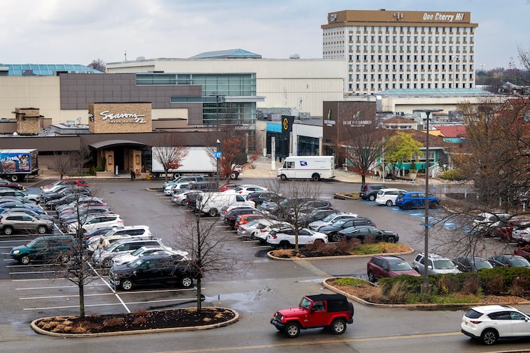 The nine-story office building One Cherry Hill (rear, right) next to the Cherry Hill Mall is being torn down and is expected to be replaced with a supersized sports retail store featuring indoor rock climbing walls and outdoor field turfs.