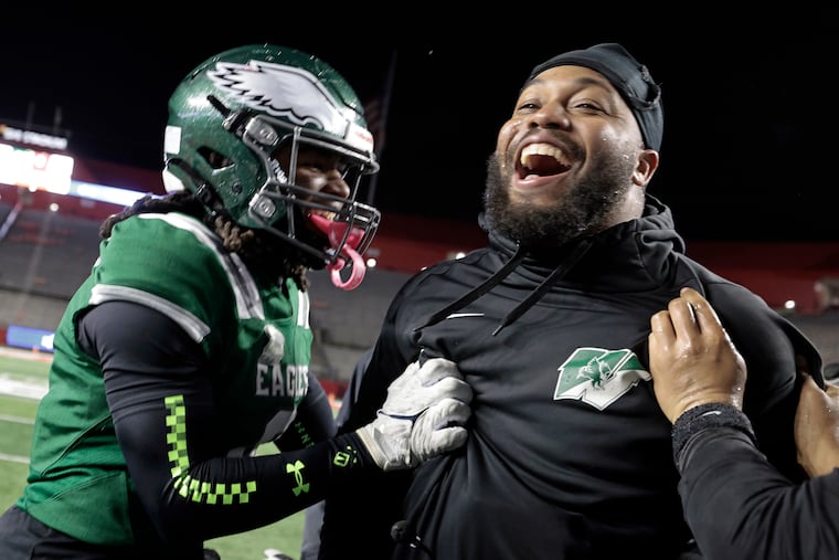 Winslow Township head football coach Bill Belton (right) and Ausar Heard celebrate after beating Phillipsburg, 35-0, for the NJSIAA Group 4 state football championship on Wednesday at Rutgers' SHI Stadium in Piscataway, N.J.