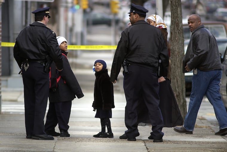 Children leave the Pierce Elementary School after a nearby morning gunfight hit student Faheem Thomas-Childs in the face and school-crossing guard Debra Smith in the foot.
