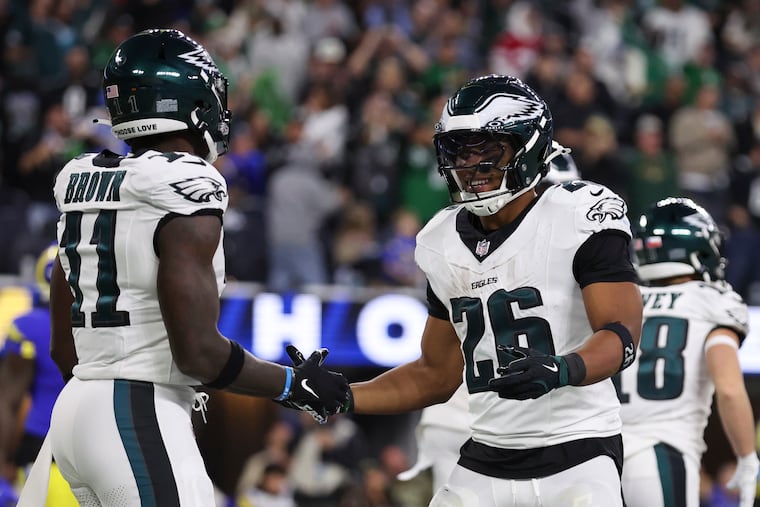 Philadelphia Eagles wide receiver A.J. Brown celebrates with running back Saquon Barkley after Barkley’s third-quarter touchdown against the Los Angeles Rams.