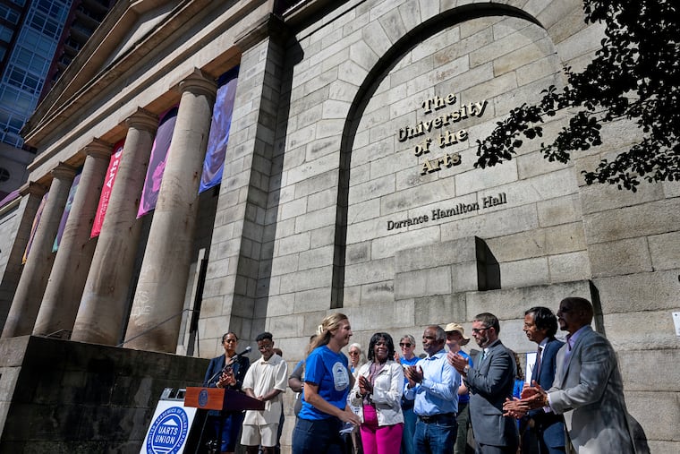 Madison Claus (center) former University of the Arts Administrative Assistant and Arts Staff Union Organizing Committee member, leaves the lectern after speaking during a press conference outside Hamilton Hall on the former University of the Arts Campus in September. The university abruptly shut in June and now is in bankruptcy.