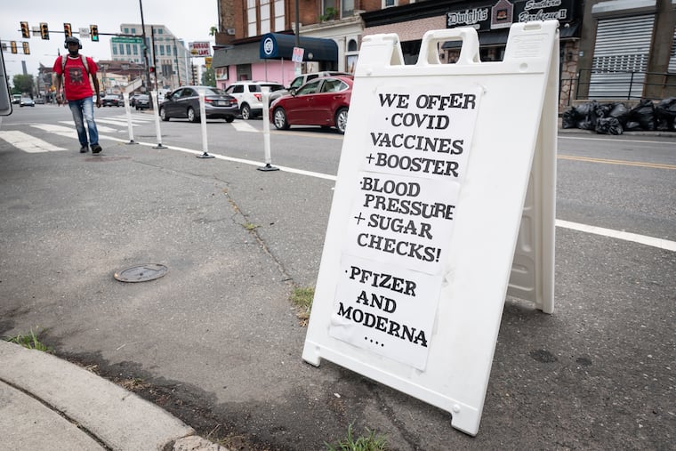 A sign with information for the August 2022 mobile clinic collaboration with  Miriam Medical Clinics, Zion Baptist Church, and Temple University.