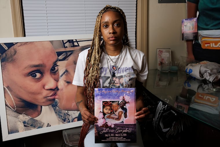 Essie Campbell holds the funeral program for her daughter, Jah'nae, who died at age 12 from an asthma attack.