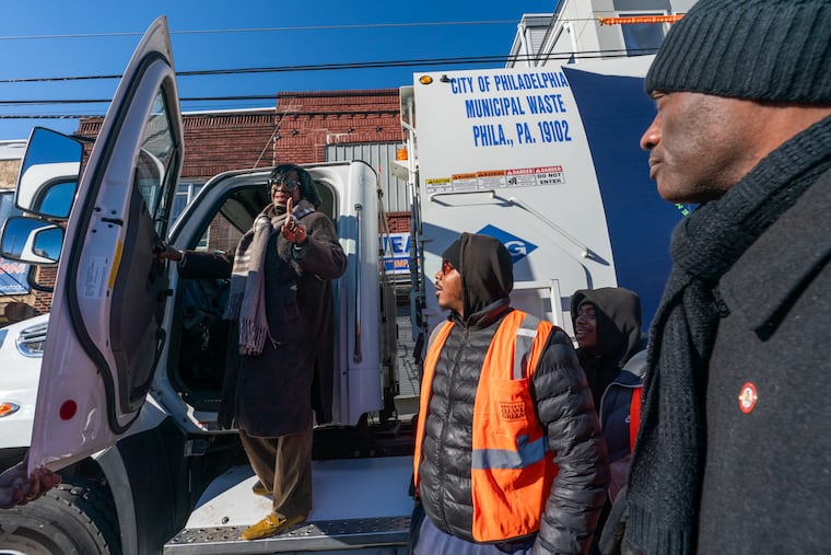 Mayor Cherelle L. Parker climbs aboard a sanitation truck Monday to announce expanded trash pickups in Center City and South Philadelphia, starting this week.
