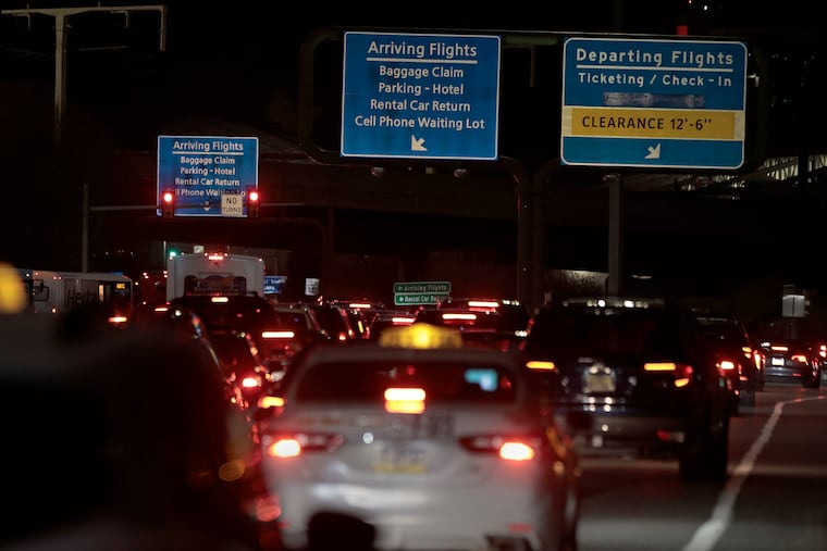 Drivers sit in traffic as they entered Philadelphia International Airport from Industrial Highway on Sunday evening. As many travelers returned home from Thanksgiving, the airport's Terminal D experienced its second power outage of the weekend from 2:30 to 5:30 p.m. Sunday, delaying about two dozen flights.
