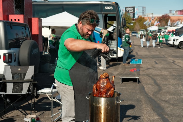 Stephen Frederick prepares a whole turkey for his tailgate at the Eagles-Jaguars game at Lincoln Financial Field on Nov. 3.