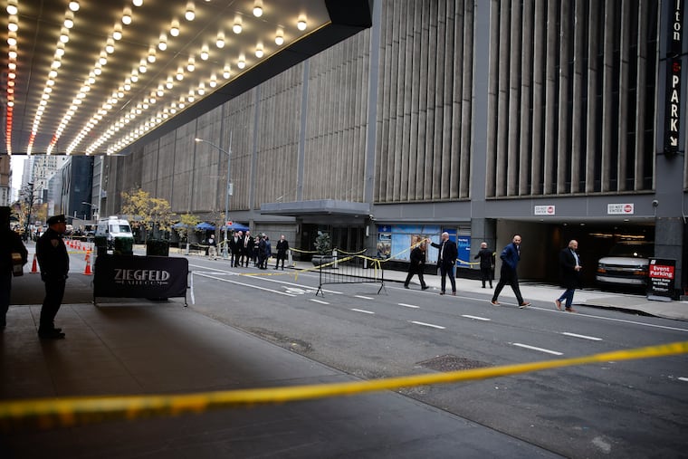 New York police investigators walk along 54th Street outside the Hilton Hotel in midtown Manhattan where Brian Thompson, the CEO of UnitedHealthcare, was fatally shot, Wednesday, Dec. 4, 2024, in New York. (AP Photo/Stefan Jeremiah)