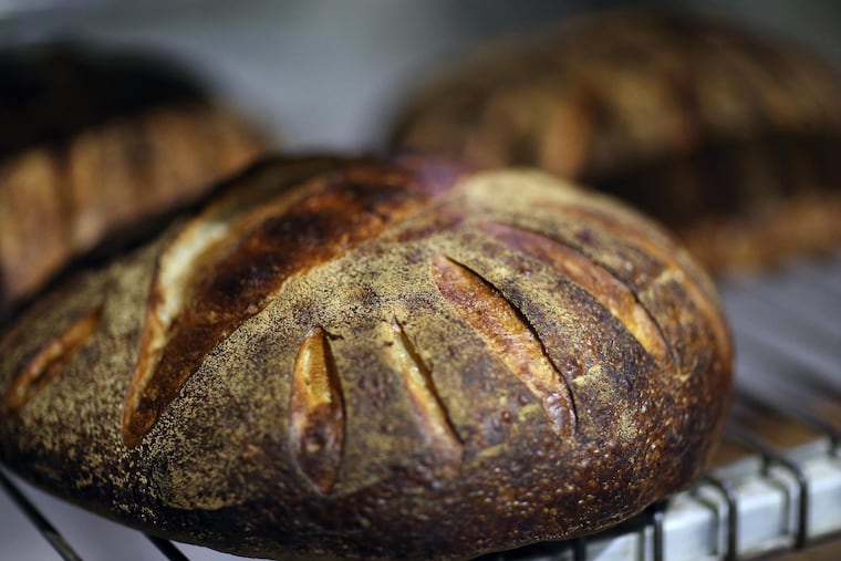 Loaves of Miche bread cool inside Metropolitan Bakery in Fishtown February 9, 2016 in Philadelphia, Pa. ( DAVID MAIALETTI / Staff Photographer )