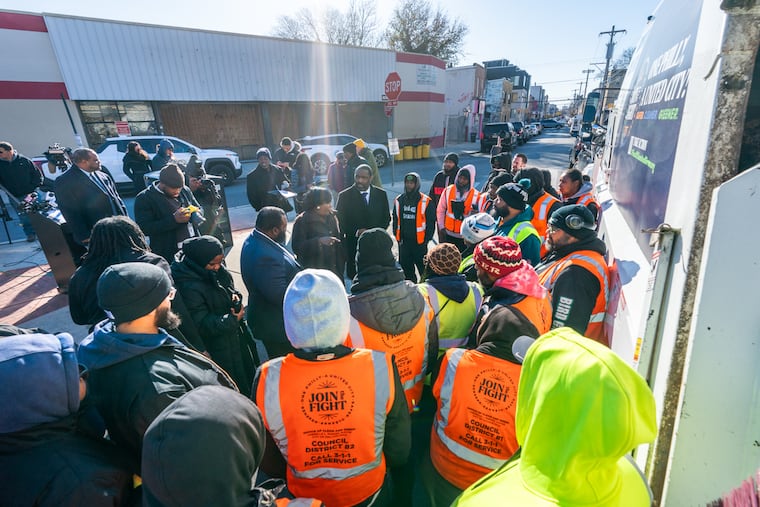 Mayor Cherelle L. Parker talks with city workers prior to a press conference to formally announce two-day trash pickup at the intersection of 1300 block of South 21st Street and Point Breeze Avenue.
