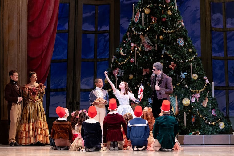 Isabella DeBiasio as Marie tries cracking nuts in her new wooden nutcracker in Philadelphia Ballet's "Nutcracker."