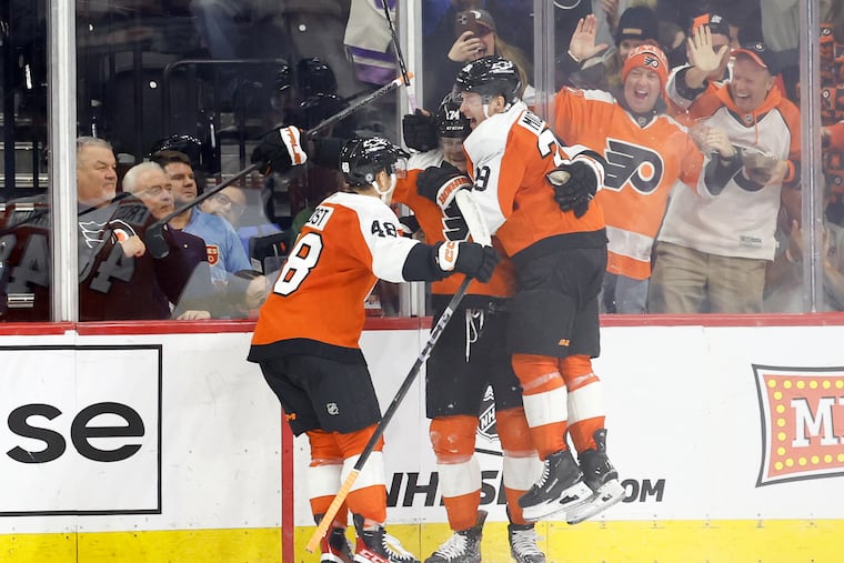 Flyers wing Owen Tippett (center) celebrates his second goal of the second period goal with his teammates Matvei Michkov (right) and Morgan Frost against the Florida Panthers.