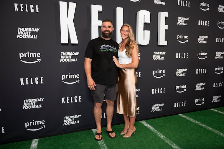 Jason Kelce (left) and his wife Kylie Kelce (right) pose for a photo together at the premier of the Jason Kelce documentary last year.