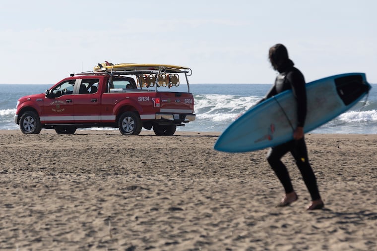 A San Francisco Surf Rescue team evacuates surfers from Ocean Beach in case of a possible tsunami on Thursday.